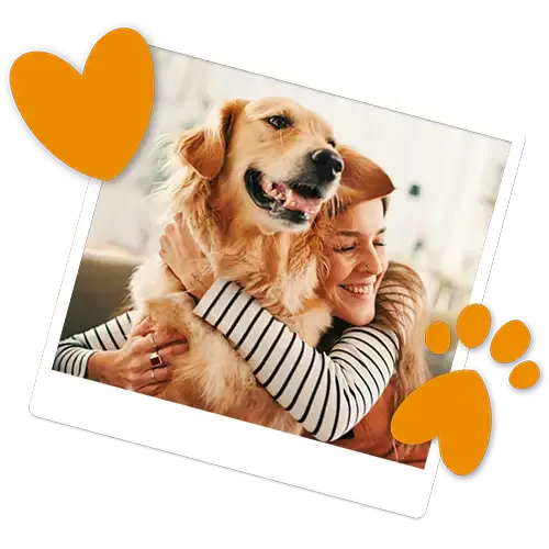 Happy dog owner cuddling their smiling dog