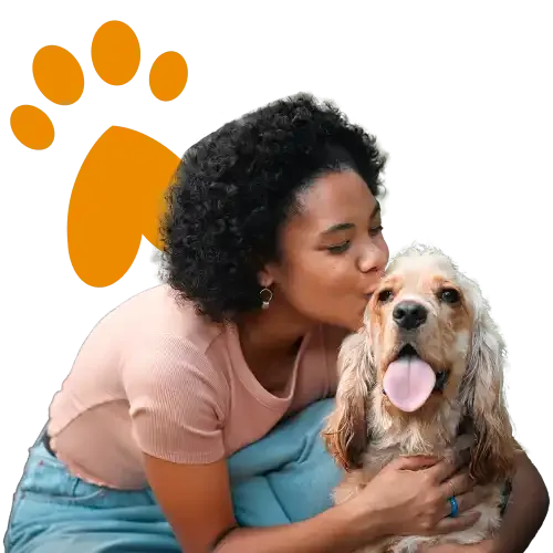 A woman kissing her Cocker Spaniel dog