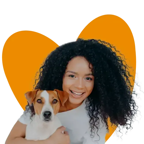 A woman cuddling her Jack Russell Terrier