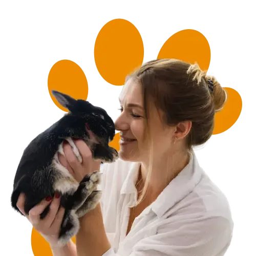 A woman kissing her pet rabbit